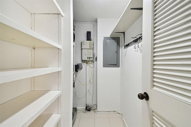 walk in closet featuring electric panel and light tile patterned floors