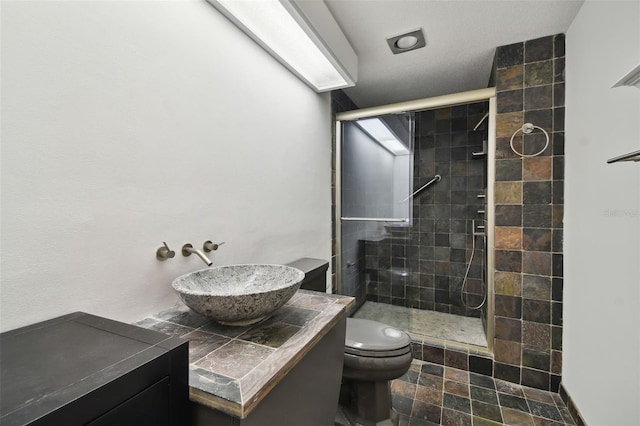 bathroom with toilet, an enclosed shower, and vanity