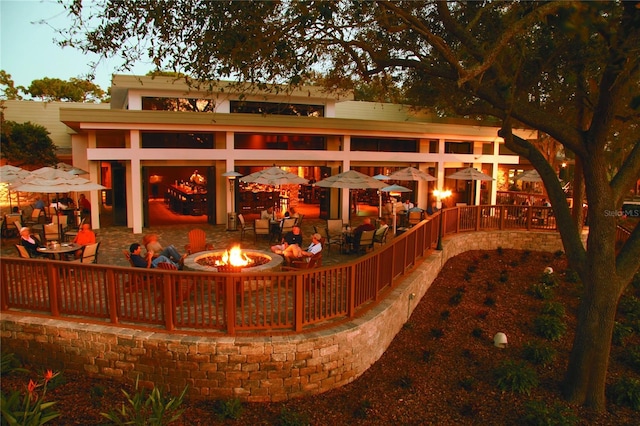 back of property featuring a patio and an outdoor fire pit