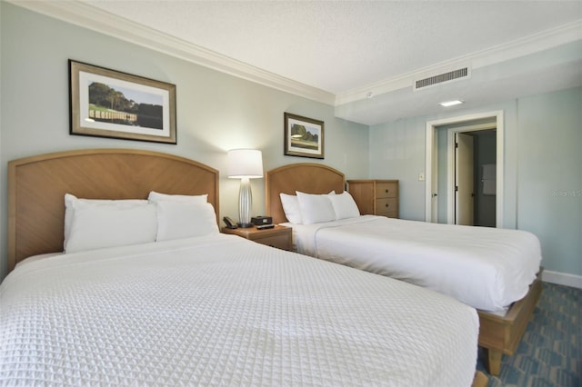 bedroom with ornamental molding, carpet, and a textured ceiling