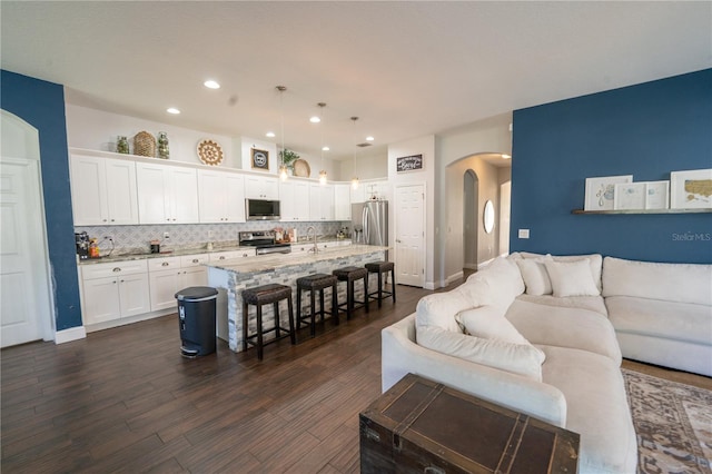 living room with sink and dark hardwood / wood-style floors