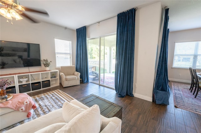 living room featuring ceiling fan and dark hardwood / wood-style flooring