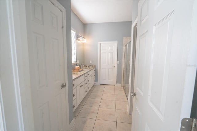 bathroom with vanity, walk in shower, and tile patterned flooring