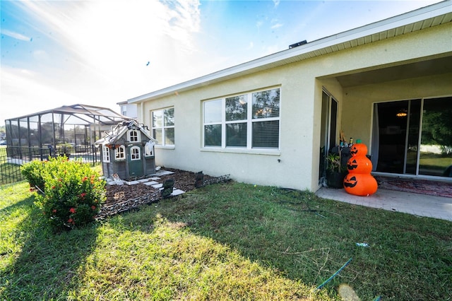 view of home's exterior with a patio area, a lanai, and a yard