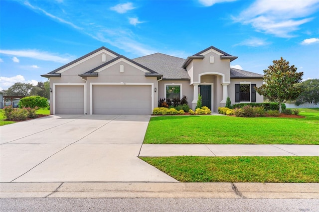 view of front of house with a front yard and a garage