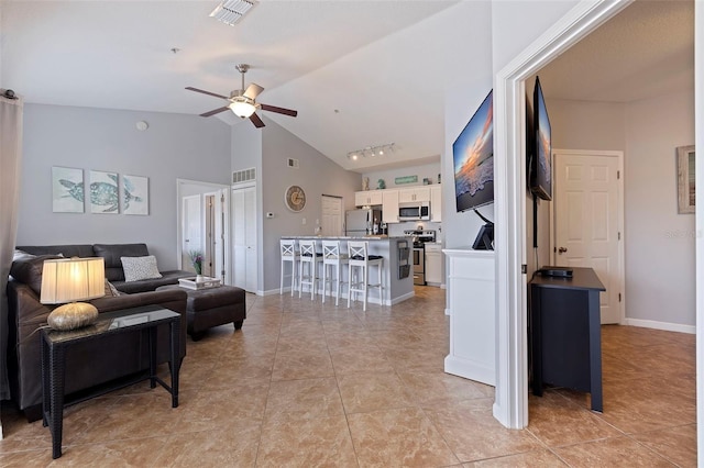 tiled living room featuring ceiling fan and lofted ceiling