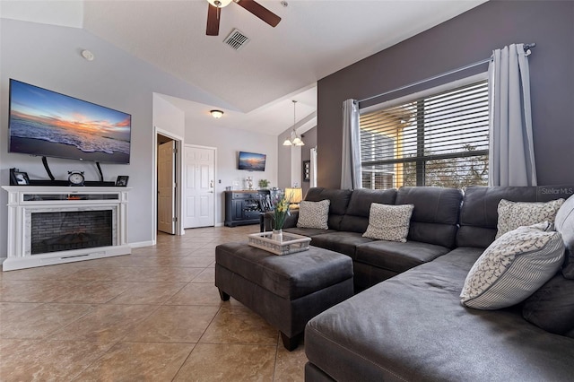 living room with tile patterned floors, vaulted ceiling, and ceiling fan with notable chandelier