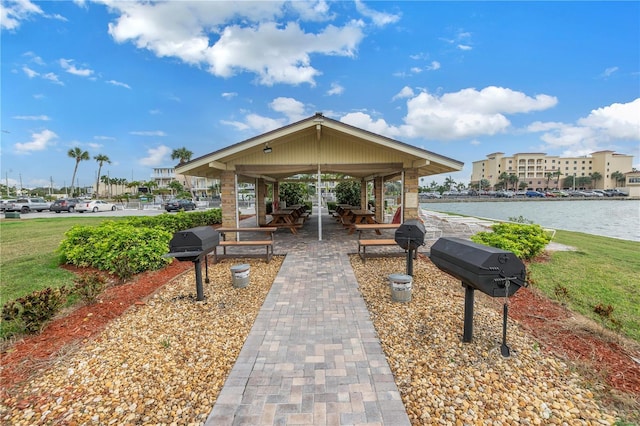 surrounding community with a water view and a gazebo