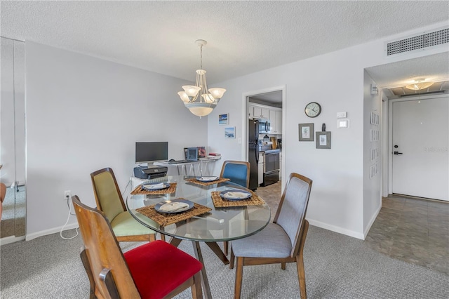 carpeted dining space featuring an inviting chandelier and a textured ceiling