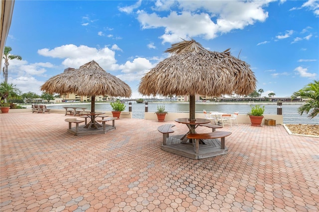 view of community with a patio and a water view