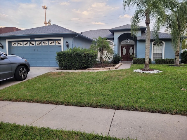 single story home featuring a front yard and a garage