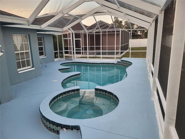 view of pool with a patio, a lanai, and an in ground hot tub