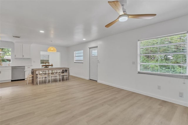 unfurnished dining area featuring ceiling fan and light hardwood / wood-style flooring