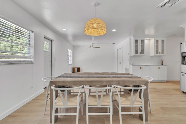 dining area featuring ceiling fan and light wood-type flooring