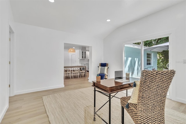 office featuring lofted ceiling and light hardwood / wood-style floors