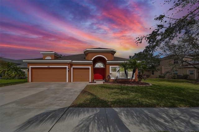 prairie-style home with a garage and a lawn