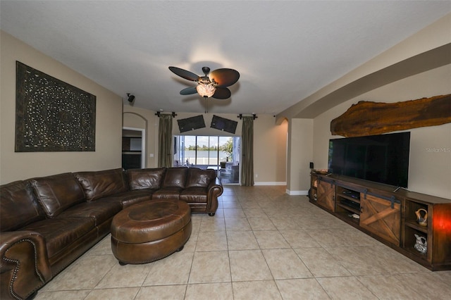 tiled living room with ceiling fan