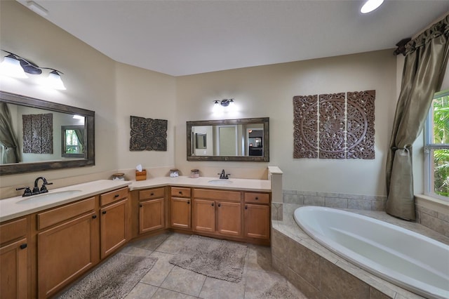 bathroom featuring vanity, tiled bath, and tile patterned floors