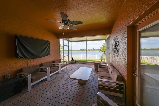 sunroom / solarium featuring ceiling fan