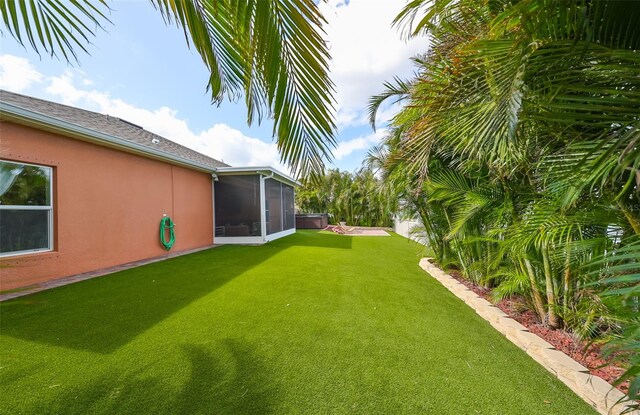 view of yard featuring a sunroom