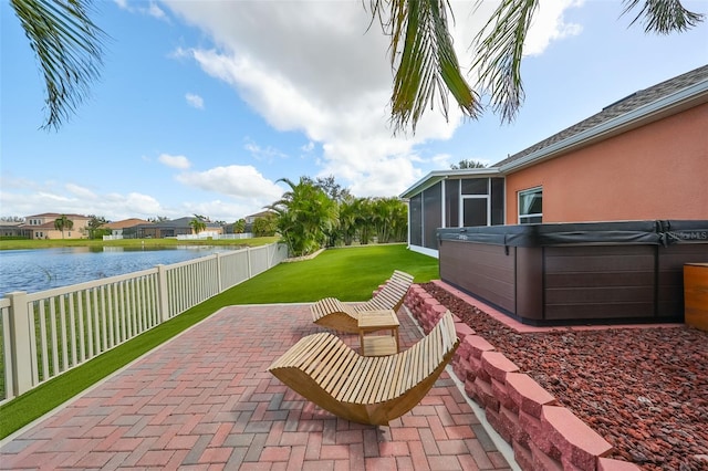 view of patio featuring a hot tub, a sunroom, and a water view