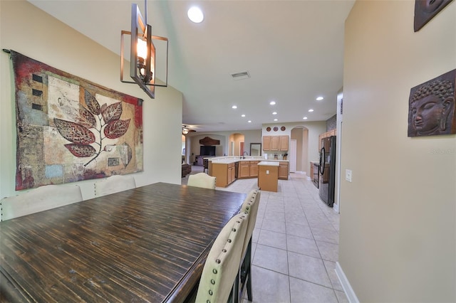 dining area featuring sink and light tile patterned floors