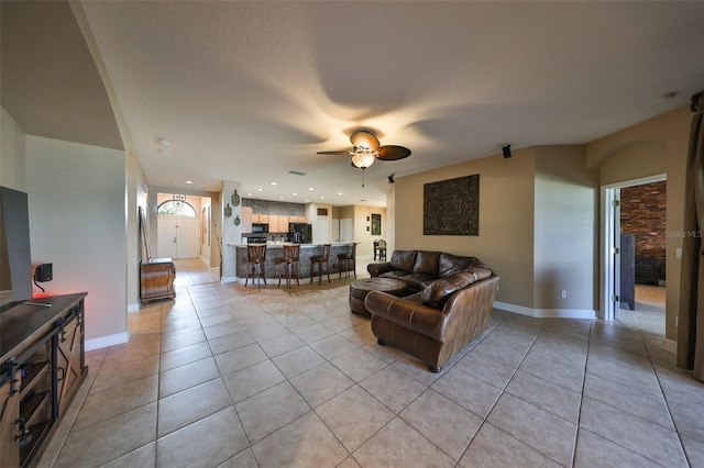 living room with light tile patterned floors and ceiling fan