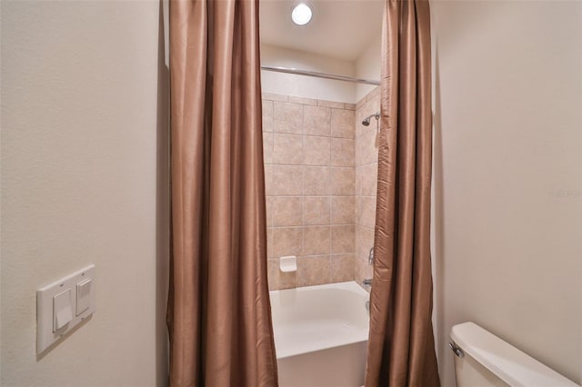 bathroom with shower / tub combo with curtain and toilet