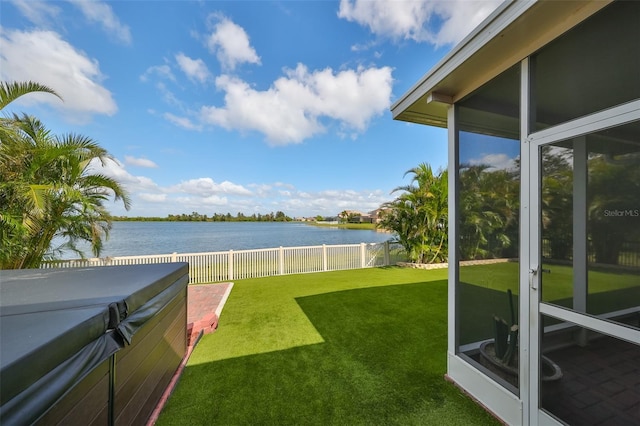 view of yard featuring a water view and a hot tub