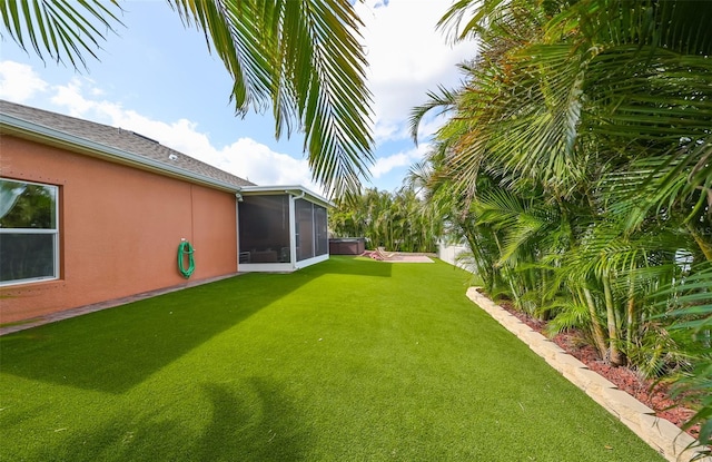 view of yard featuring a sunroom