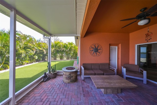 view of patio with ceiling fan and an outdoor fire pit