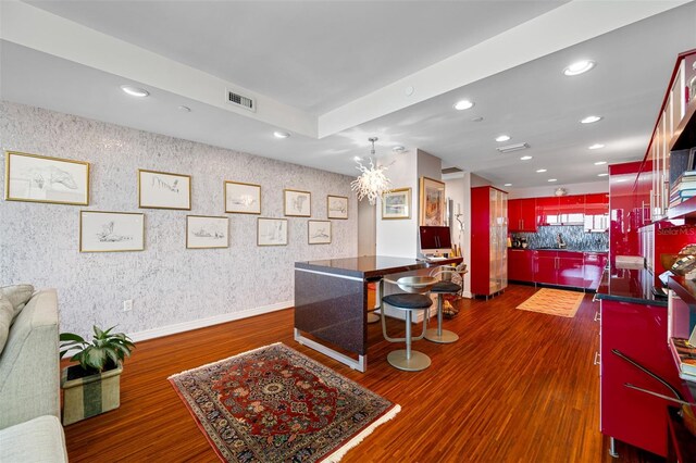 interior space featuring a chandelier, kitchen peninsula, and dark hardwood / wood-style floors