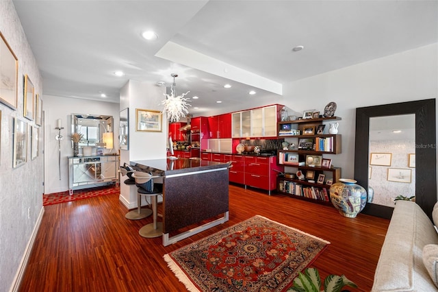 living room with a chandelier, dark wood finished floors, and recessed lighting