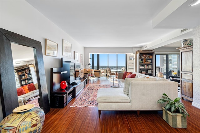 living room with a wealth of natural light and hardwood / wood-style flooring