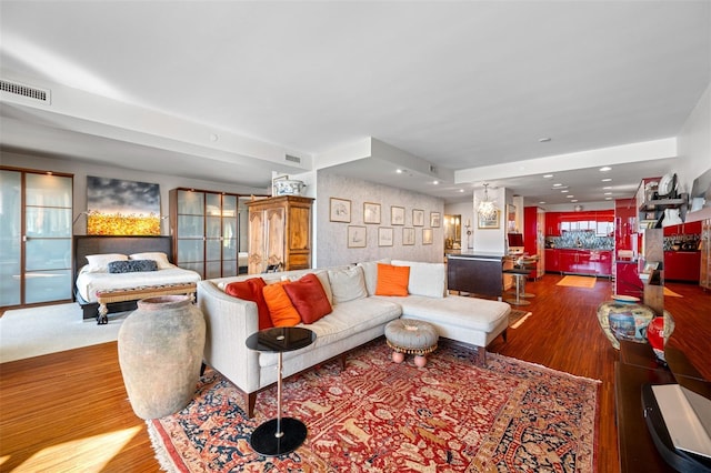 living room with visible vents and wood finished floors