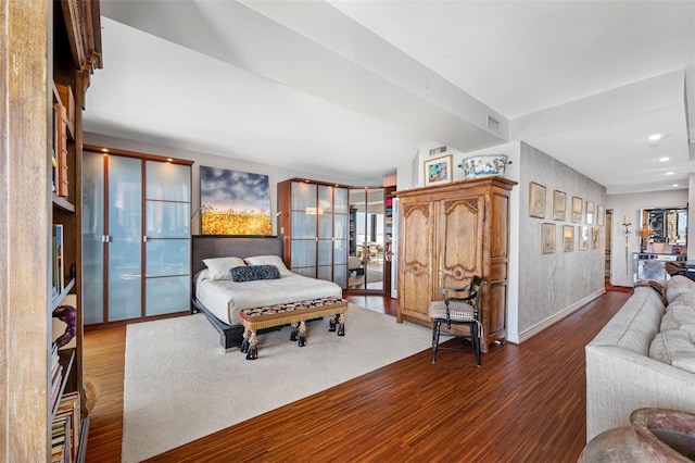 bedroom with baseboards, french doors, wood finished floors, and visible vents