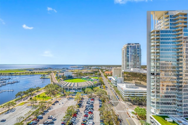 birds eye view of property with a view of city and a water view