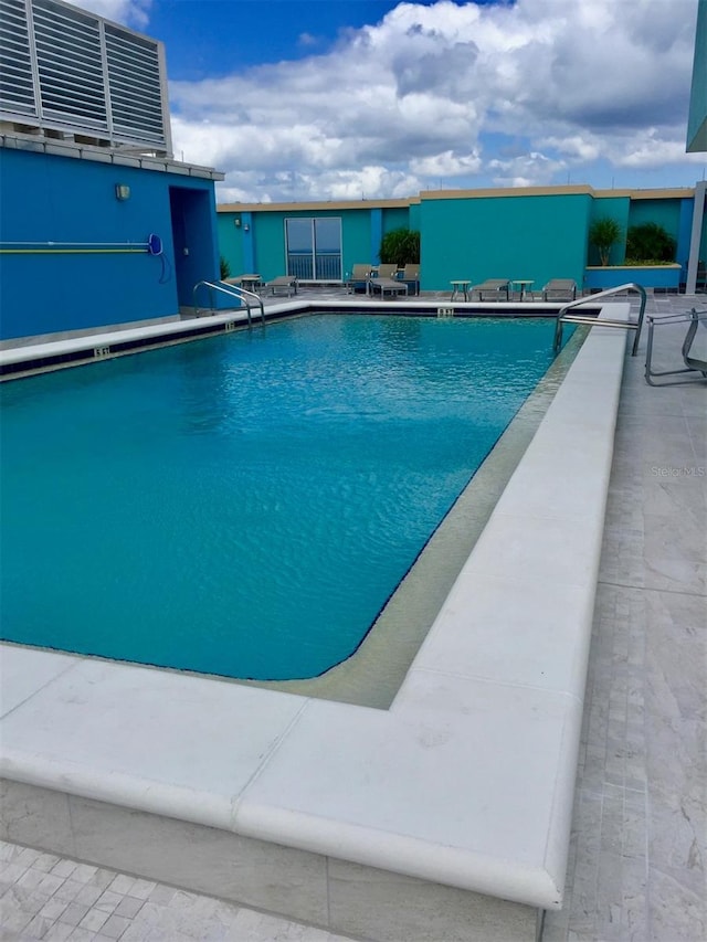 community pool with a patio area