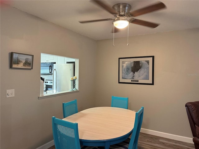 dining area featuring dark hardwood / wood-style floors and ceiling fan