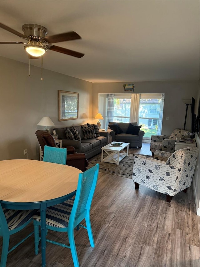 living room featuring hardwood / wood-style floors and ceiling fan