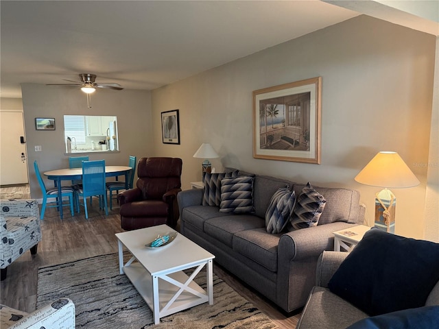 living room with wood-type flooring and ceiling fan