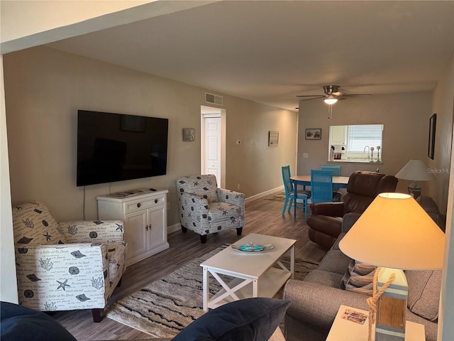 living room featuring sink, ceiling fan, and dark hardwood / wood-style flooring