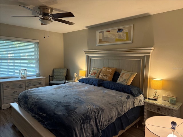 bedroom with ceiling fan and dark hardwood / wood-style flooring