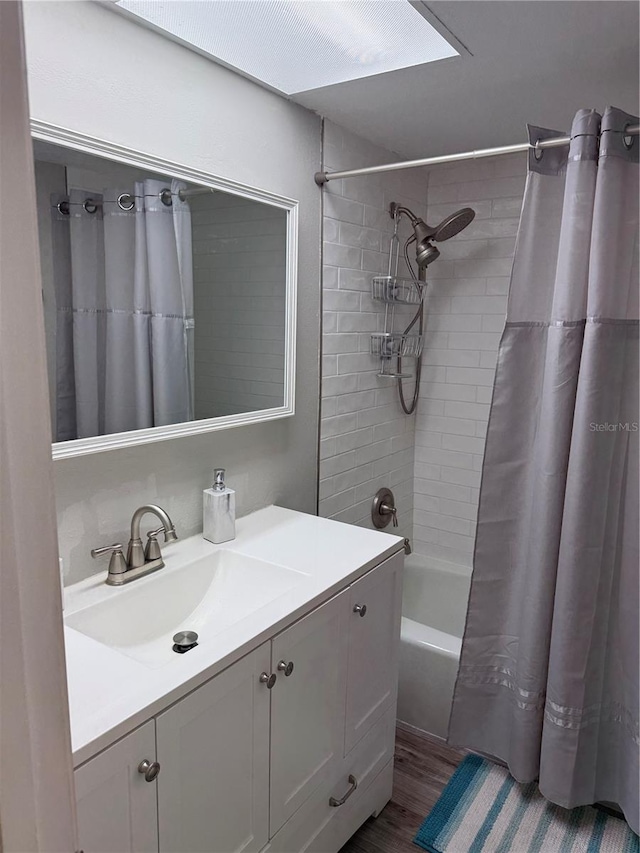 bathroom featuring vanity, hardwood / wood-style flooring, and shower / tub combo