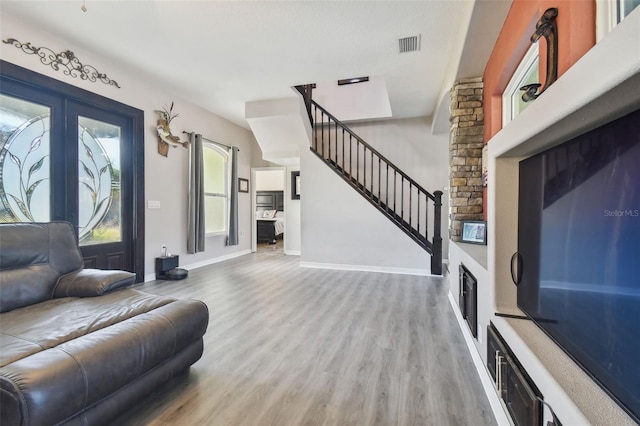 living room featuring french doors and hardwood / wood-style flooring