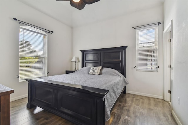 bedroom with dark hardwood / wood-style floors and ceiling fan