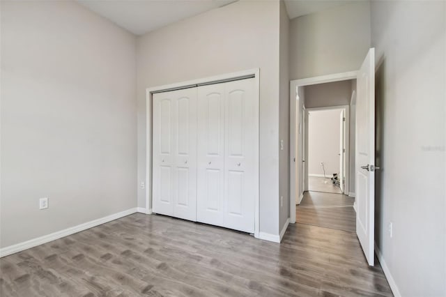 unfurnished bedroom featuring a closet and hardwood / wood-style floors