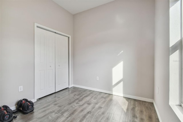 unfurnished bedroom with a closet and light hardwood / wood-style floors