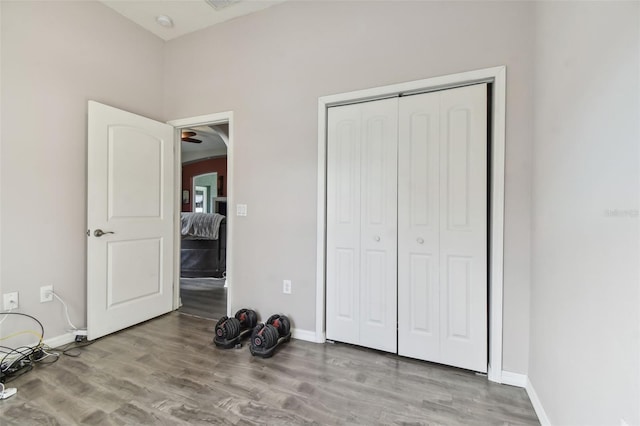 unfurnished bedroom featuring a closet and light wood-type flooring