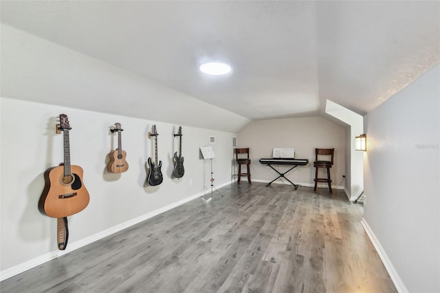 bonus room with lofted ceiling and hardwood / wood-style floors